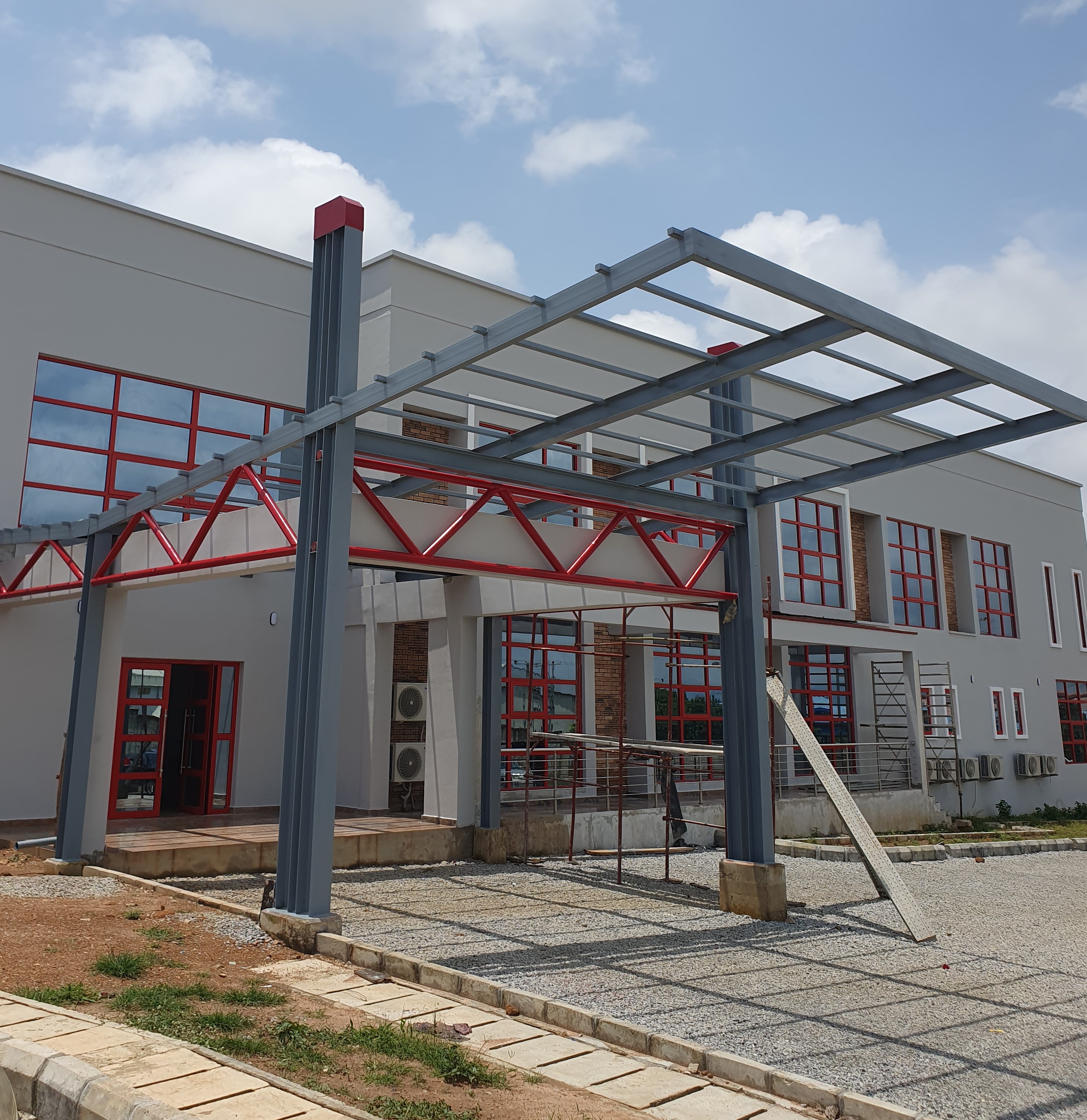 Modern Steel Entrance Canopy with Red & Grey Truss Design